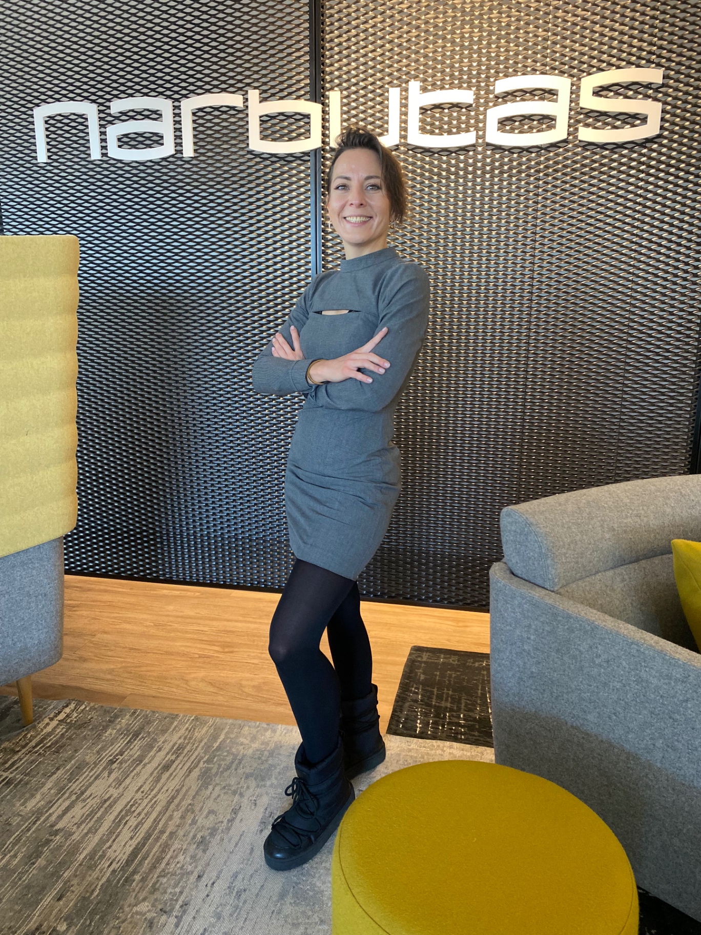 Anna Kai during her corporate years, in front of a Narbutas office wall
